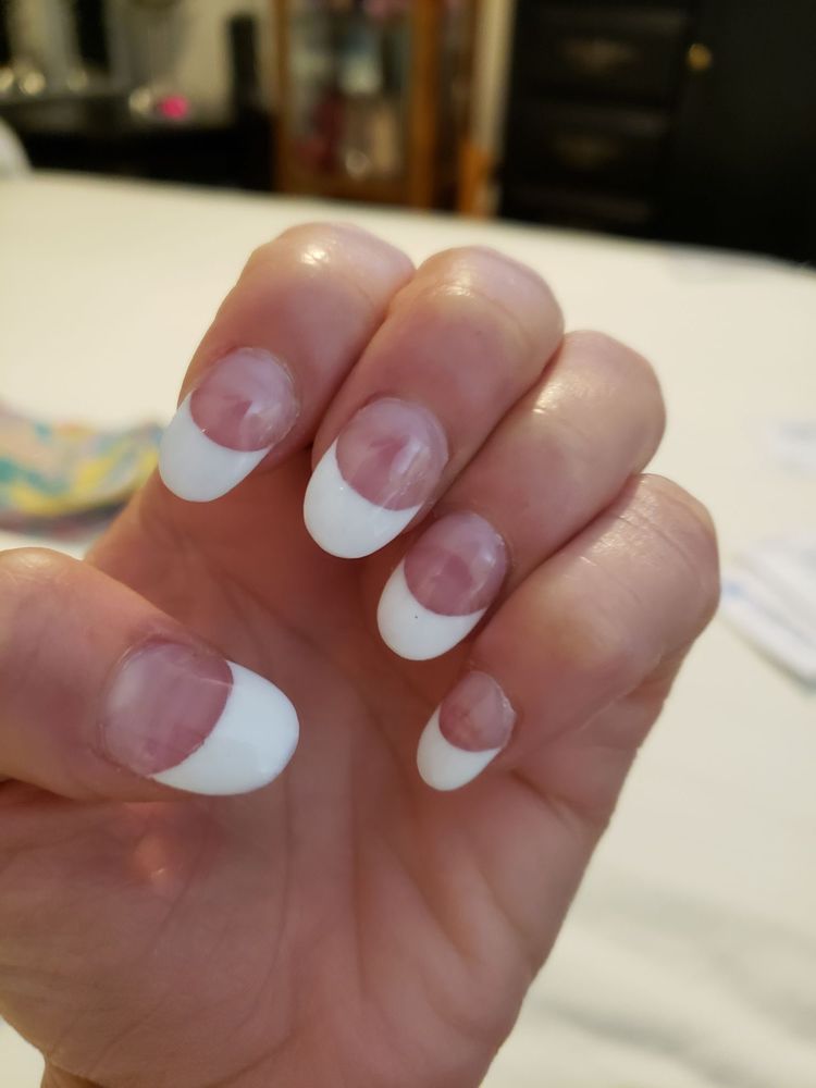 Classic French manicure with crisp white tips on rounded nails