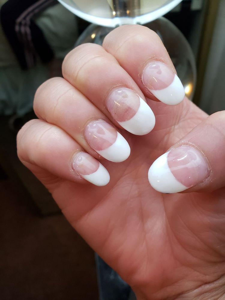 Almond-shaped French manicure with glossy white tips and clean pink base